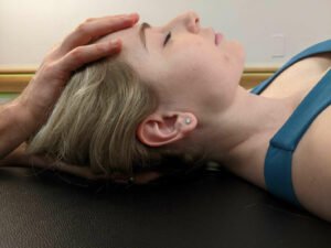 Gentle hand on head during a Craniosacral Therapy Session (CST).